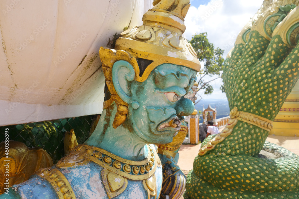 Poster guard detail statue on the top of the mountain in wat tham suea, krabi, thailand