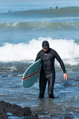 surfer walking on the beach coast