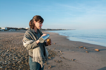woman on the beach drinking mate