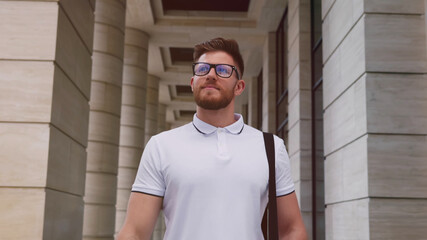 Smiling entrepreneur walking outside business center