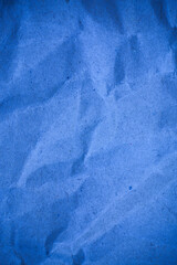 Textured crumpled packaging blue paper background.