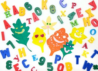 Colorful of randomly placed letters  and numbers with funny leaves from paper, place for text