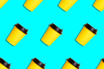 Seamless pattern of illuminating yellow paper coffee cups on bright blue background