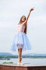 Fototapeta na wymiar Portrait of a young stylish girl in blue skirt