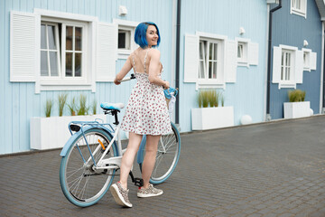 Cute lesbian on a white bike with busket.