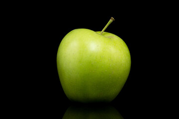 Green apple on a black background.