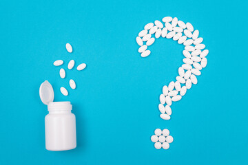 Question Mark Made from White Pills and Tablets with Pill Container, Lying on Blue Background. Global Pharmaceutical Industry and Medicinal Products