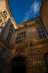 Obraz premium architecture castle palace house exterior facade side golden stone wall and windows photography foreshortening from below vertical picture