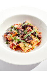 Tuna Cannelloni pasta - noodles plate with tuna fish meat. Pasta dish with tuna, tomato sauce and rocket salad. Restaurant gourmet cannelloni pasta food plate isolated on white background..