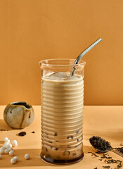 Tapioca pearls black tea and caramel refreshing drink. Modern look, poster. Copy space concept.