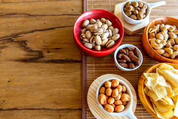 Healthy snack, beans, cassava chips, pistachios, chickpeas, peanuts and almonds.