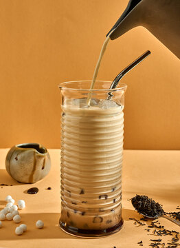 Tapioca pearls black tea and caramel refreshing drink. Modern look, poster. Copy space concept.