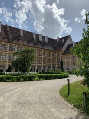 Fototapeta na wymiar Stainz, Austria, June 23, 2021. Stainz Castle in the Austrian state of Styria. Today the Baroque complex belongs to the Counts of Merano. The courtyard of the former monastery 