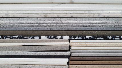 close up view of artificial stone samples in catalog box showing multi texture, color and pattern...