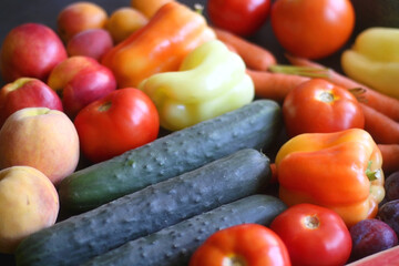 Various colorful summer fruit and vegetable on dark background. Selective focus.