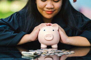 graduates holding piggy banks saving concept