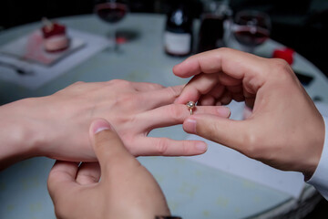 the guy made offers to his girlfriend and puts on a ring