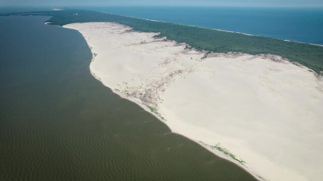 Curonian Spit, Efa dune. A sand dune is bordered by a forest.