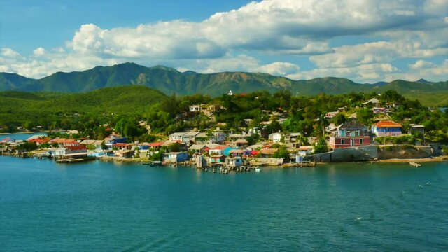 Cuban poor colorful village with church on the hill near city Santiago de Cuba 