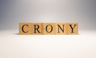 Crony was created from wooden cubes. News and journalism concepts.