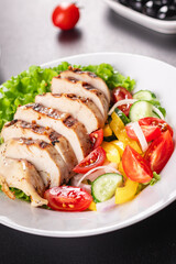 salad grilled chicken breast vegetables tomato, cucumber, onion, pepper outdoor meal snack on the table copy space food background rustic. top view keto or paleo diet