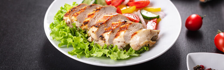 salad grilled chicken breast vegetables tomato, cucumber, onion, pepper outdoor meal snack on the table copy space food background rustic. top view keto or paleo diet