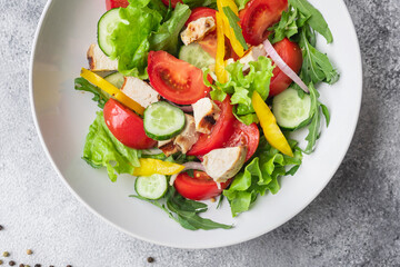 salad fresh vegetables lettuce leaves tomato, cucumber, onion, pepper outdoor meal snack on the table copy space food background rustic. top view keto or paleo diet veggie vegan or vegetarian food