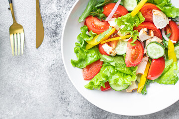 salad fresh vegetables lettuce leaves tomato, cucumber, onion, pepper outdoor meal snack on the table copy space food background rustic. top view keto or paleo diet veggie vegan or vegetarian food