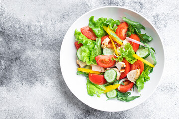 salad fresh vegetables lettuce leaves tomato, cucumber, onion, pepper outdoor meal snack on the table copy space food background rustic. top view keto or paleo diet veggie vegan or vegetarian food