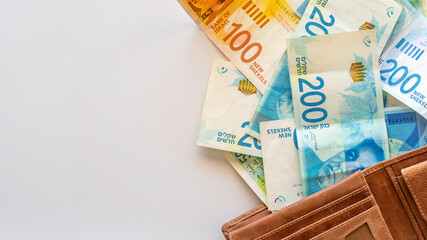 Israeli shekels on white background with copy space.