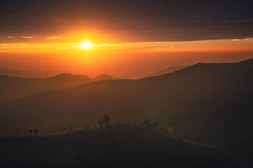 Sunrise on agriculture farmland hilltop in countryside at morning