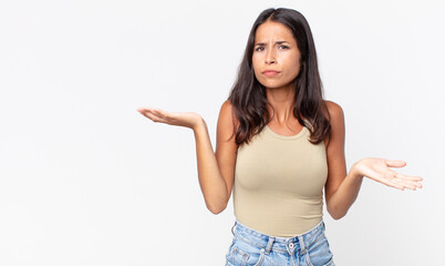 pretty thin hispanic woman looking puzzled, confused and stressed