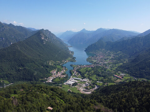 Aerial view over Lake Idro, northern Italy. The lake is surrounded by wooded mountains. It's a famous place for hiking, camping, cycling, excursion, and relaxing.