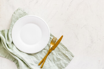 Table setting overhead view - plate with cutlery set and napkin