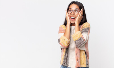 pretty thin hispanic woman feeling happy, excited and surprised