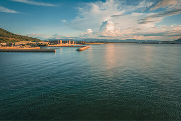 Fototapeta premium Aerial Top View from Flying Drone, Landscape of The Sea or Ocean in Evening in Summer, Takamatsu City in Kagawa Prefecture in Japan