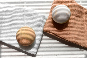 Autumn spa aromatherapy concept with beige bath bombs on towels. Zen concept for natural beauty cosmetic, massage. Wellness. Sunlit minimalist still life for eco products