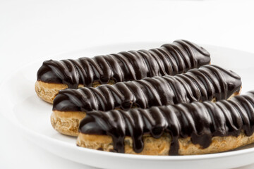 Dessert Bomba de Chocolate. Brazilian traditional éclair on a white background.  Selective focus.