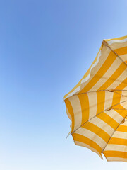 yellow umbrella on clear blue sky .summer holidays concept 