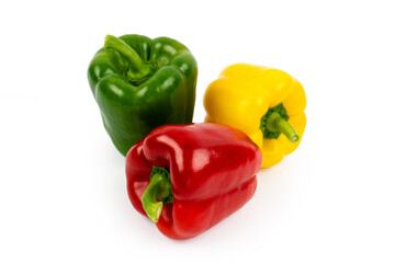 Three sweet bell peppers of red, yellow and green color isolated on white background. Side view