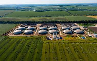 Production of sustainable fuel called bio gas. New factory in field. View from above. Ecological...