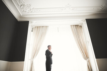 Beautiful man, groom posing and preparing for wedding