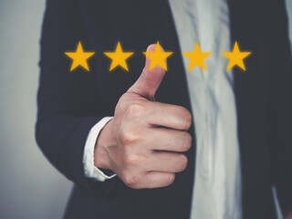 Customer review good rating concept hand pressing five star on visual screen and positive customer feedback testimonial		