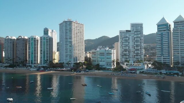 Beautiful view of the beach, aerial view of the beach, acapulco beach seen from above. Travel and vacation concept. Colorful sunset on the beach. Aerial video