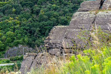 Rock formations on the edge of a cliff above a river in West Germany.