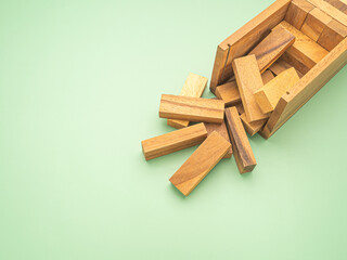 Table game made of wooden blocks isolated on a green background. Space for text