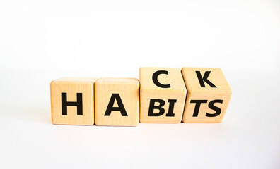 Hack habits symbol. Turned wooden cubes with words 'Hack habits'. Beautiful white table, white background. Psychology, hack habits concept. Copy space.