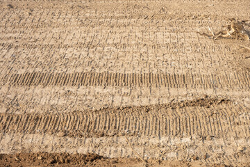 dry soil with tyre mark as background and texture
