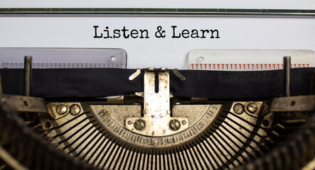 Listen and learn symbol. Words 'Listen and learn' typed on retro typewriter. Business, educational and listen and learn concept. Copy space.