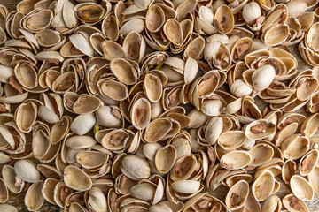 Empty shells of pistachio nuts background.